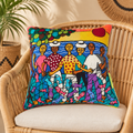 Cojín decorativo bordado con diseño original de José Morillo, motivo pescadores, sobre una silla de mimbre